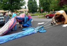 After the inflated balloon was "walked" across Summerfield Drive to the Clubhouse parking lot and deflated, the crew rolled up the balloon and stuffed it into a canvas bag