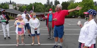 King City Residents Hold Independence Day Parade, Honors 2020 Graduates and First Responders King City parade organizer Louis Martinez (in the red shirt) explains to parade participants the route they will take around the Golf Course.