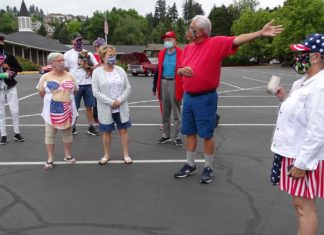 King City Residents Hold Independence Day Parade, Honors 2020 Graduates and First Responders King City parade organizer Louis Martinez (in the red shirt) explains to parade participants the route they will take around the Golf Course.