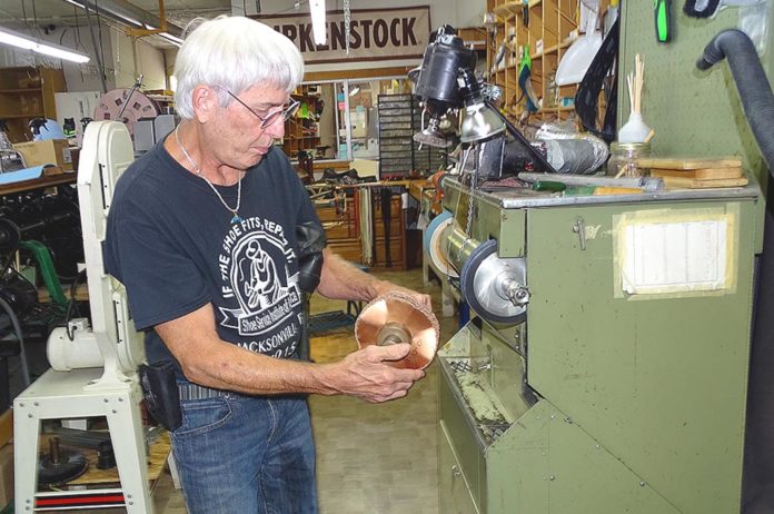 Don Myers operates a jack sander using a 24-grit carbide wheel in his Tigard shoe repair shop. Photos by Barbara Sherman.