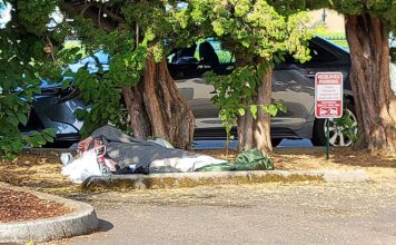 Downtown Tigard the epicenter of local homelessness A homeless person sleeps in a downtown Tigard parking lot.