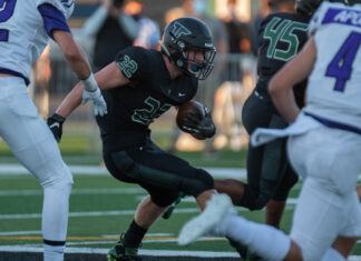 Tigard junior Konner Grant runs the ball in the first of the Tigers' 48-6 season opening loss to Sunset on Sept. 3, 2021, at Tigard High School.