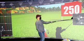 After Ken Reigle hits the ball, the aboutGOLF software generates all the information about his swing on the giant screen.