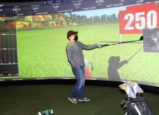 Golf around the world at Infinity Golf After Ken Reigle hits the ball, the aboutGOLF software generates all the information about his swing on the giant screen.