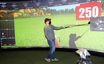 Golf around the world at Infinity Golf After Ken Reigle hits the ball, the aboutGOLF software generates all the information about his swing on the giant screen.