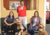 Surrounding a cardboard cutout of “Jake,” State Farm Insurance’s chief advertising spokesperson, are Mark Creevey’s office “staff,” (from left) Gillian Moreno, Creevey holding his golden-doodle Willow, Sarah Kimsey-Sauro and visiting golden-doodle Olive.