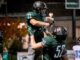 Rain or shine, Tigard football takes the field Junior Reese Hare (52) lifts up Henry Masters (23) in celebration.