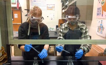 Educators, students alike, brave the transition back to the classroom Tigard High chemistry teacher Kelsey Wahl has her students in the fume hood performing labs.