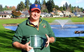Zach Palmer, who just started on the job June 1, holds his glass plaque for winning the Oregon Golf Association’s superintendent of the year award.