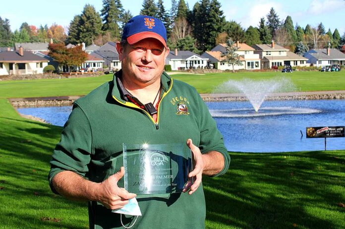 Zach Palmer, who just started on the job June 1, holds his glass plaque for winning the Oregon Golf Association’s superintendent of the year award.