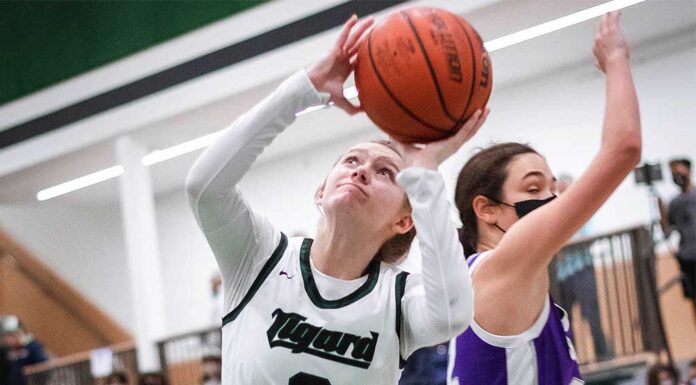 Girls’ basketball springs back into action, COVID adds difficulty Sophomore and first-time varsity Ocean Deisner (3) puts up a shot.