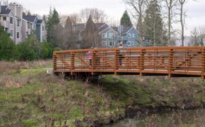 Shown here, an existing pedestrian bridge connecting Ash Street to the Fanno Creek Trail.