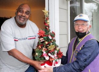 Bill Gerkin has been volunteering almost non-stop since retiring 30 years ago Meals On Wheels People volunteer driver Bill Gerkin (right) hands a Christmas tree to Donald Daniel.