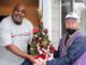Bill Gerkin has been volunteering almost non-stop since retiring 30 years ago Meals On Wheels People volunteer driver Bill Gerkin (right) hands a Christmas tree to Donald Daniel.