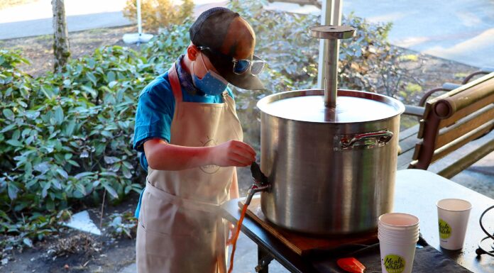 Young Philanthropist Brews Big Benefit to Fight Hunger Cooper pouring coffee from Nossa Familia’s giant, custom welded French Press at a Feb.12 Cooper’s Coffee pop-up outside of Meals On Wheels People at the Tigard Senior Center.