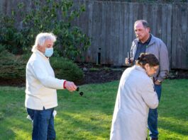 Roger Potthoff (left) and his wife consult with local Tigard pest control company owner Randy Witten about the rat problem in his backyard.