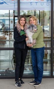 Jaz Zawideh (left) and Kathy Mertens with 14-year-old shop dog Tucker.
