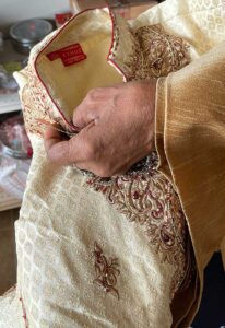 The traditional Indian silk groom’s suits Devi Nadarajah imports are hand embroidered with intricate beadwork. She carries ceremonial, formal and casual Indian clothing.