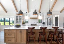 This modern farmhouse kitchen mixes painted cabinets with a rift-sawn white oak island.