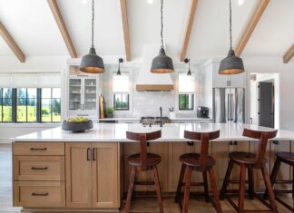 Add Personality to your Home this Year This modern farmhouse kitchen mixes painted cabinets with a rift-sawn white oak island.