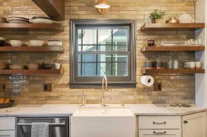 A porcelain tile feature wall gives an organic, lived-in feel to the kitchen’s back wall.