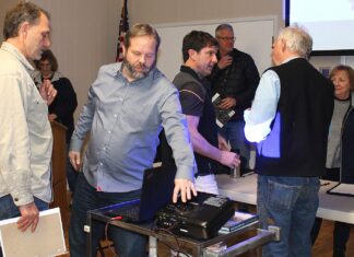 Residents still wary of Kingston Terrace Transportation System Plan Following a Kingston Terrace public meeting Feb. 8, an attendee talks to city planning consultant Steve Faust with 3J Consulting (second from left), while King City City Manager Mike Weston (third from left) chats with another attendee.