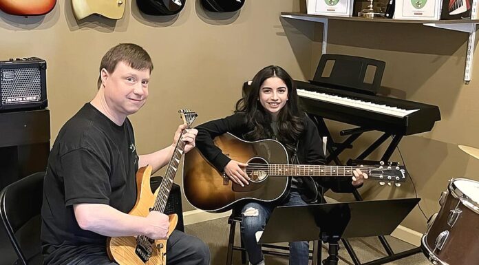 Tigard Business Spotlight: King City Guitar Ben Rector (left) with student at King City Guitar.
