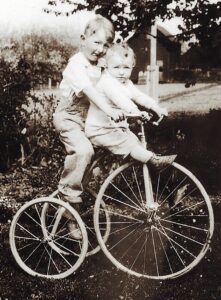 Richard and Estelle Gaarde ride a tricycle.           