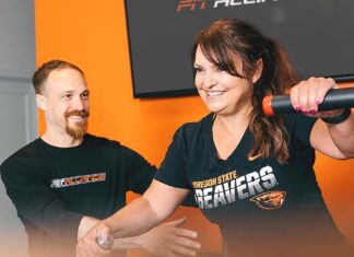 Fat Loss Secrets for Women Over 40 – Part 1 Jordon Hice (left) assists Michelle on a multi-hip machine.