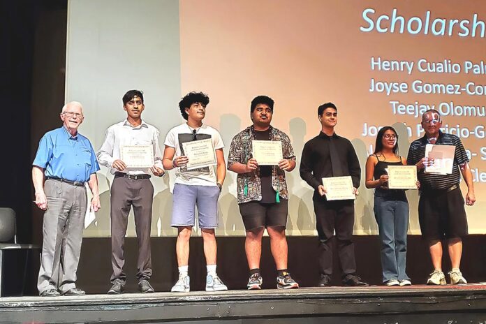 King City Lions Club members Bill Gerkin (far left) and Rick Castle (far right) stand with the Tualatin High School seniors who were awarded Lions club scholarships at the school’s awards ceremony in June.