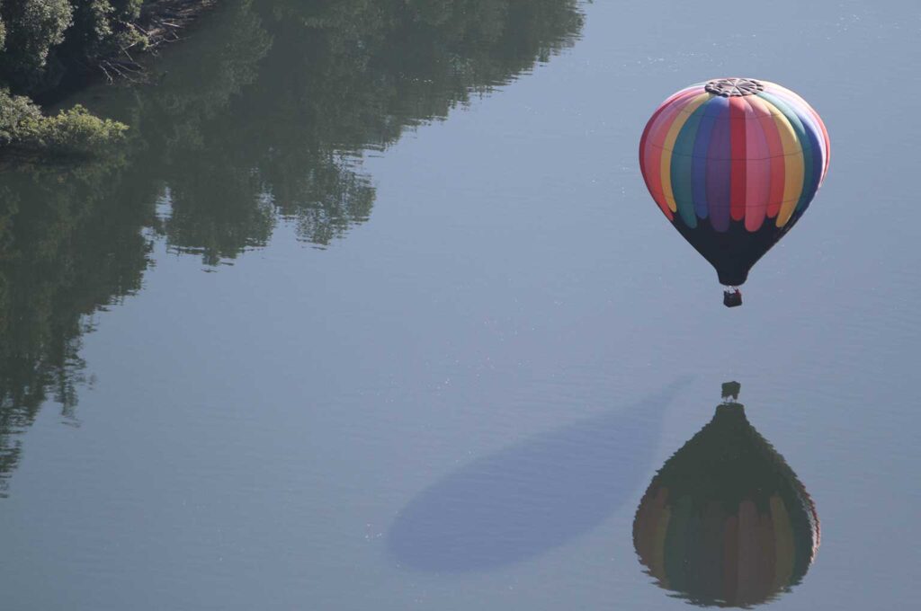 Pilot Robert Raper takes his balloon, Fallen Angels, right above the Willamette River during a flight Friday morning as part of the Tigard Festival of Balloons.