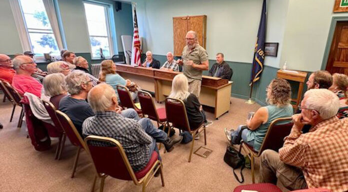 Journalists, Oregon publishers call on governor to veto bill changing public meetings law Roger Averbeck addresses his neighbors at a meeting of the Wallowa County Commission on Aug. 23, 2023. A new law meant to clarify what Oregon's public officials can discuss in serial communications to one another, such as calls and texts, is concerning to journalists and ethics watchdogs who say it erodes public meetings laws and allows important decisions to be made in private. (Photo by Matt Vasilogambros/Stateline)