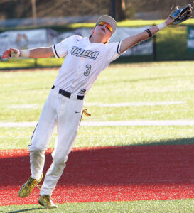 Tigard junior Cade Randall reaches for a fly ball during a preseason game.