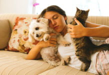 New Puppy or Kitten? Start Off on the Right Foot Woman on couch with pets