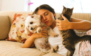 New Puppy or Kitten? Start Off on the Right Foot Woman on couch with pets
