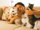New Puppy or Kitten? Start Off on the Right Foot Woman on couch with pets
