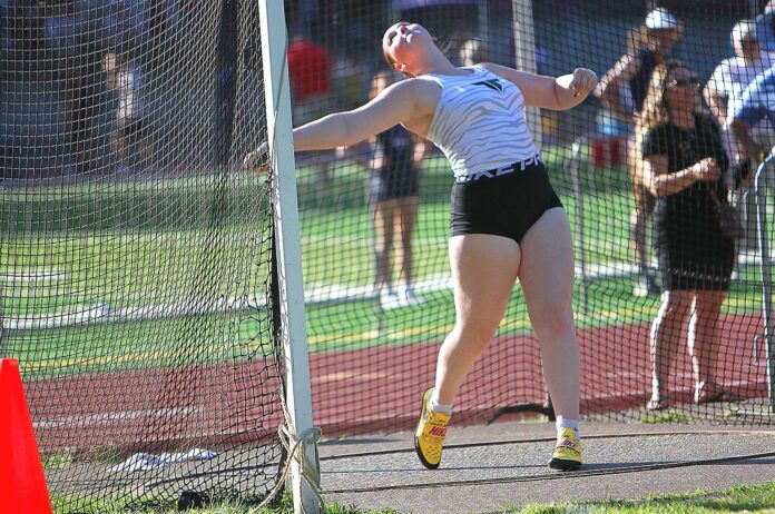 Tigard senior Marissa Johnson competes in discus at the Three Rivers League en route to winning her fourth straight state title in the event, this one coming just three months after surgery for a torn labrum.