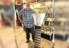 Tigard store channels gold-mining magic Dan Rouse, owner of Prospector's Treasure Trove, stands with a sluice box in front of a display case showing gold-mining artifacts in his store.