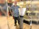 Tigard store channels gold-mining magic Dan Rouse, owner of Prospector's Treasure Trove, stands with a sluice box in front of a display case showing gold-mining artifacts in his store.