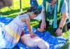 Tigard CERT: Preparedness Starts with Community A child learning CPR at Tigard CERT Fair