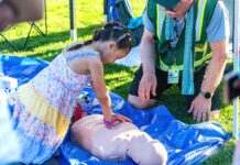 Tigard CERT: Preparedness Starts with Community A child learning CPR at Tigard CERT Fair