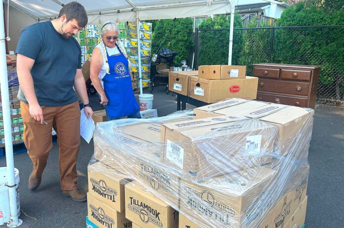 Director of St. Vincent De Paul Food Pantry Jackson Fischer and Vice President of St. Vincent De Paul Diane Bohan helped load a new shipment of food into the pantry on July 15, 2026