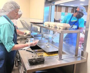 Vice President of St. Vincent De Paul Diane Bohan helped cook food in the kitchen during a Sunday Community Cafe. 