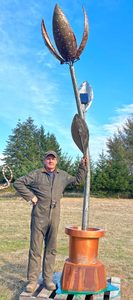 Oregon artist Ben Dye stands next to his over 12-foot-tall "Solar Bloom" sculpture