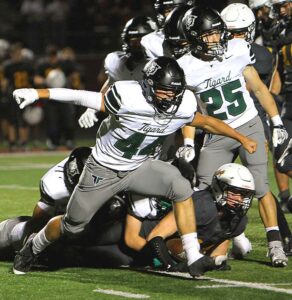 Tigard freshman Grayson Cardenas celebrates a big hit in the Tigers loss to Milwaukie.
