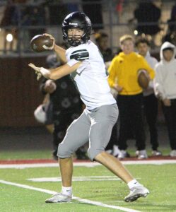 Tigard senior quarterback Aris Dimick looks to make a pass in the Tigers loss to Milwaukie.
