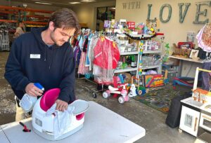 Family Support Specialist Chad Nagel organizes recently donated supplies on Oct. 23. 