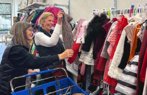 With Love volunteers fill out foster families orders by looking through available items.